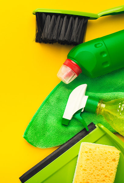 House cleaning products and supplies on yellow isolated background, top view. Spring cleaning and household concept. Mockup for advertisement with copy space